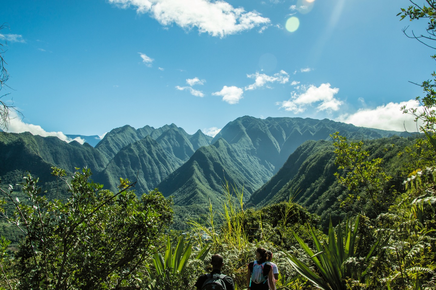 Randonneurs face aux montagnes verdoyantes de La Réunion, zone d'intervention de REUNIREM DIAGNOSTIC